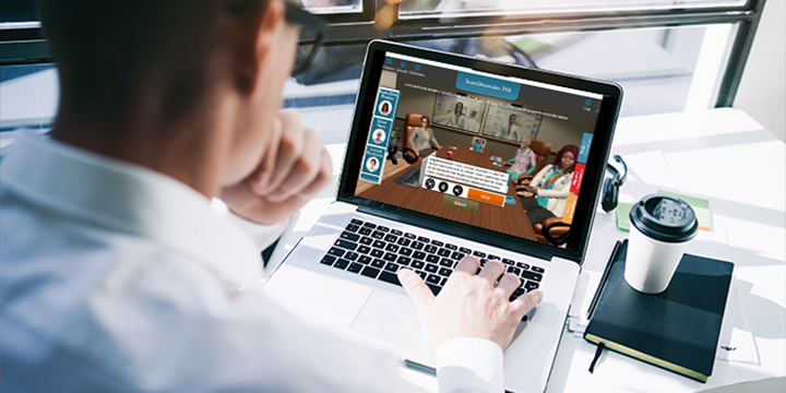 A man looking at a laptop that is displaying the Interprofessional Teams virtual simulation